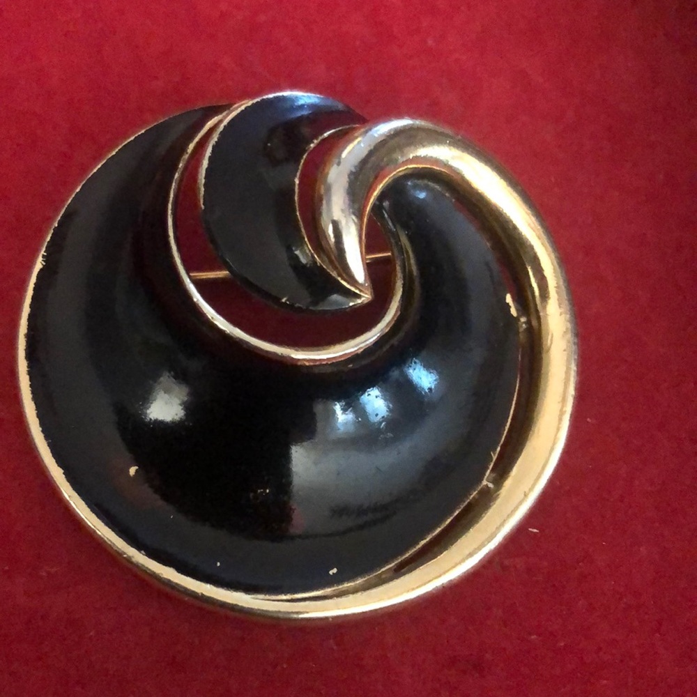 Vintage gold and black enamel Trifari round  pin.